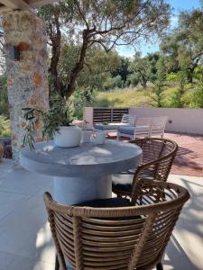 a table and chairs on a patio at Stone build suite with private pool in Kolios