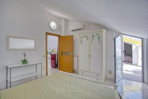 a large room with a bed and a table at Grandmother's Attic in Furore