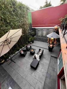 an overhead view of a patio with chairs and umbrellas at Luxurious Mid Century Modern folk art home in Mexico City