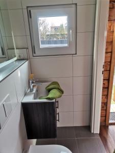 a small bathroom with a sink and a window at Kleine Auszeit in Waren