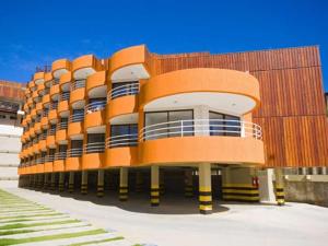 a large orange building with balconies on the side of it at Marsallis Residence Flat-EFM601 in Natal