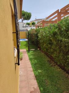 a walkway next to a house with a fence at Matalascañas in Matalascañas