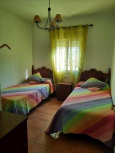 two beds in a room with rainbow at Matalascañas in Matalascañas