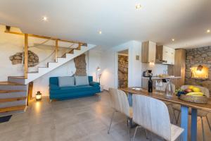 a kitchen and living room with a blue couch at Mljet, old stone apartment with pool in nature in Babino Polje