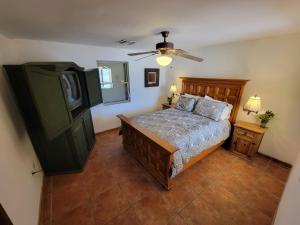 a bedroom with a bed and a ceiling fan at Casa Medusa at Cholla Bay Rocky Point by Castaways in Puerto Peñasco
