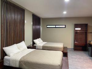Ein Bett oder Betten in einem Zimmer der Unterkunft Huasteca Em suites