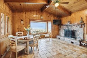 a dining room with a table and a fireplace at The Big Sky in Pearblossom