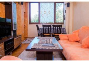 a living room with a couch and a table at Luxury apartment on the first line to the sea in Burgas City