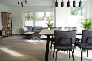 a living room with a table and chairs and a couch at Haus Seeadler 2 EG in Dangast