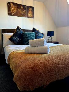 a bedroom with a bed with two pillows on it at Forget Me Not Cottage in Ironbridge