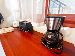 a blender sitting on a wooden table next to a window at Casa Iluminalia in Abraão