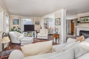 a living room with white furniture and a fireplace at SeaCity View in Swampscott