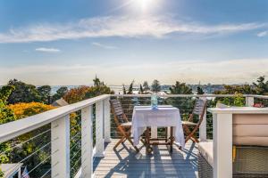 a table and chairs on a balcony with a view at SeaCity View in Swampscott