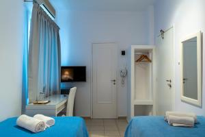 A bed or beds in a room at Manto Hotel
