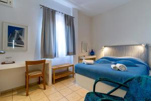 A bed or beds in a room at Manto Hotel