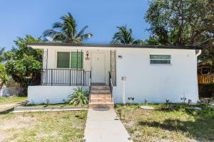 a white house with a porch and a door at Florida style House 10 min from the beach in Hallandale Beach