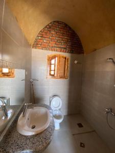 uma casa de banho com um lavatório e um WC em Lala Land Camp em Nuweiba