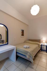 A bed or beds in a room at Manto Hotel