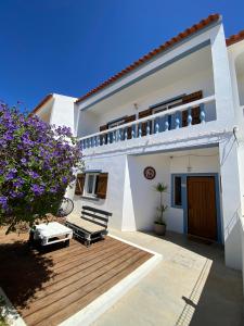 a white house with a deck and a balcony at Casa Boa Onda in Sagres