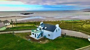 an aerial view of a white house on the beach at Costa Glebe in Dungloe