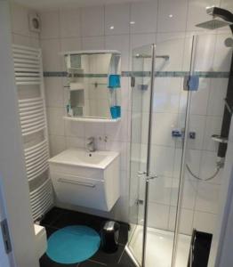 a bathroom with a toilet and a glass shower at Apartment Abel in Hannover