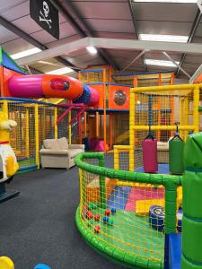 a play room with a slide and play equipment at welcome to B4 in Aberystwyth