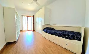 a bedroom with a bed and a wooden floor at Casa de la Luz in Carboneras