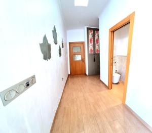 a hallway of a house with a door and a wooden floor at Casa de la Luz in Carboneras