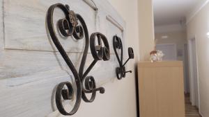 a metal wall art with the word love on a wall at B&B SoleMare in Taranto