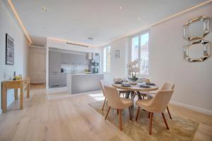 a kitchen and dining room with a table and chairs at STANDING - NEUF - Croisette- Palais des festivals - 6 pers -3 chbres in Cannes