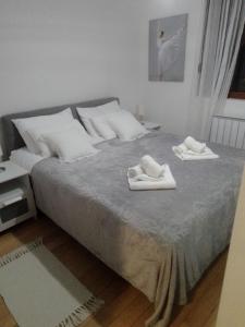 a bedroom with a bed with two towels on it at Nektar 88 in Vrnjačka Banja +39 photos