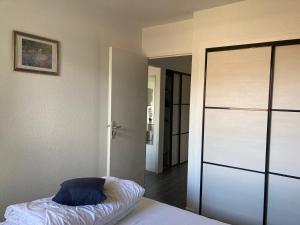 a bedroom with a bed and a sliding glass door at A LA DECOUVERTE DE NICE in Nice