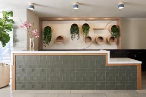 a lobby with a row of toilets with plants at Kimpton Hotel Enso by IHG in San Francisco