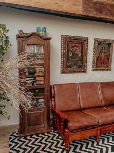 a living room with a couch and a book shelf at Casa Amada in Arraial d'Ajuda