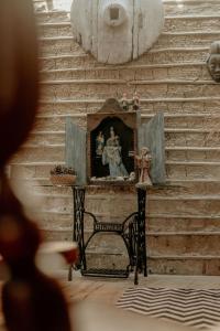 a small altar with a picture of a woman on a table at Casa Amada in Arraial d'Ajuda