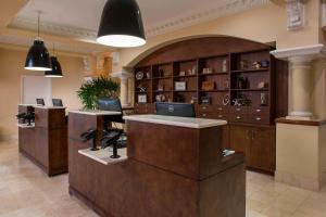 a lobby with a desk with two laptops on it at Four Points by Sheraton Suites Tampa Airport Westshore in Tampa