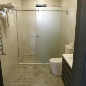 a bathroom with a shower with a toilet and a sink at Chilagir_garden in Qusar +5 photos