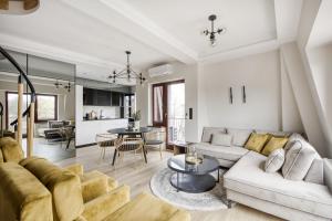 a living room with a couch and a table at Masuria Apartments in Giżycko