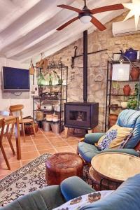 uma sala de estar com sofás e uma lareira de pedra em Finca Sábila em Valle de Abdalagís