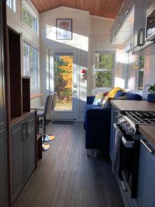 a kitchen and living room of an rv at Modern Private Tiny House in the Forest in Slocan