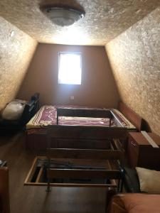 a small room with two beds and a window at Vikendica Komovi in Andrijevica