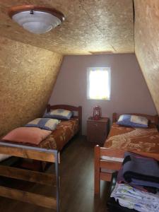 a room with two beds and a window at Vikendica Komovi in Andrijevica