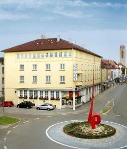 a building with a red object in the middle of a street at Schöne Stadtwohnung in Friedrichshafen am Bodensee in Friedrichshafen