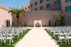 a wedding aisle with white chairs and a marquee at Sheraton Mesa Hotel at Wrigleyville West in Mesa