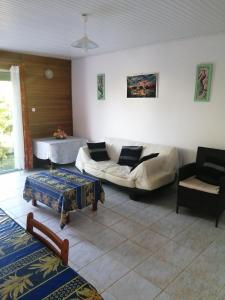 a living room with a couch and a table at chez arlette in Petit-Bourg