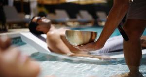 a person holding a spoon in a swimming pool at Wailea Beach Resort - Marriott, Maui in Wailea