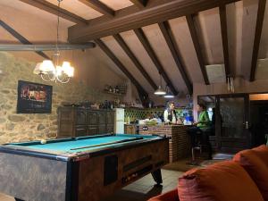 a room with a pool table in a kitchen at La Torre de Vilanna in Bescanó