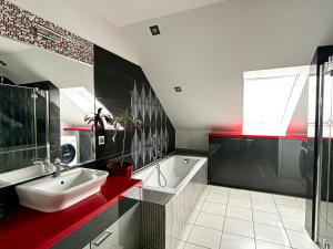 a bathroom with a sink and a bath tub and a window at Pokoje na Jasełkowej in Szczecin +45 photos