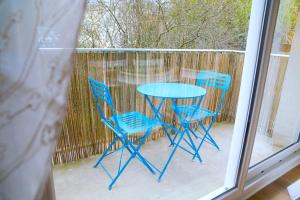 a blue table and two chairs on a patio at Douceur Angevine in Angers