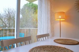 a dining room table with a view of a window at Douceur Angevine in Angers